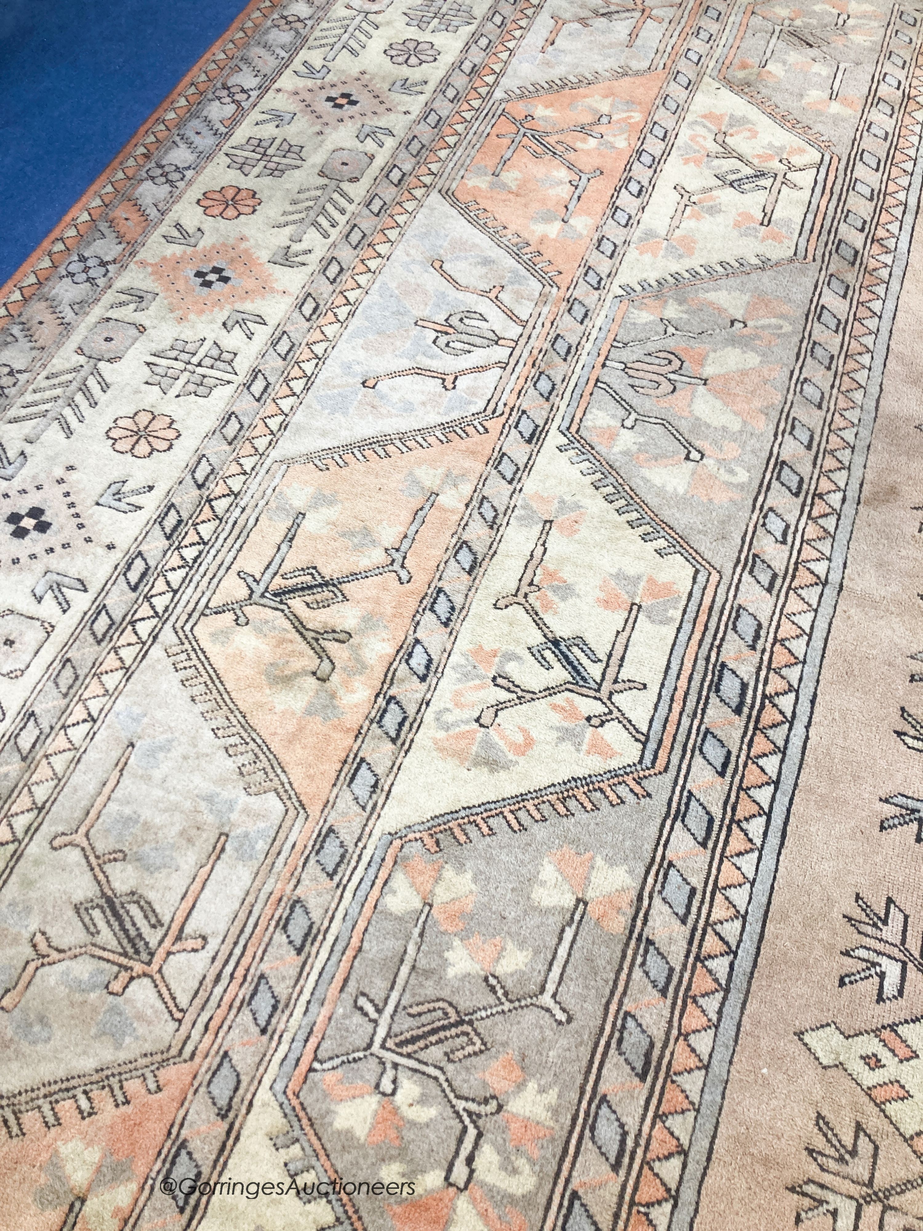 A large Caucasian Turkish design fawn ground carpet, 420 x 300cm